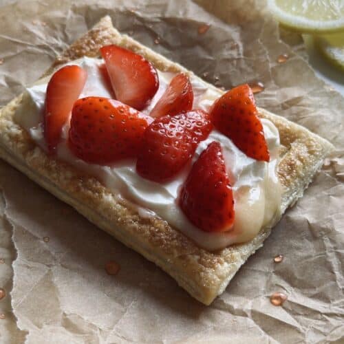 A strawberry and mascarpone tartlet on parchment paper
