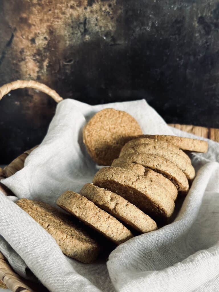 Some almond and rye cookies in a basket lined with a linen napkin
