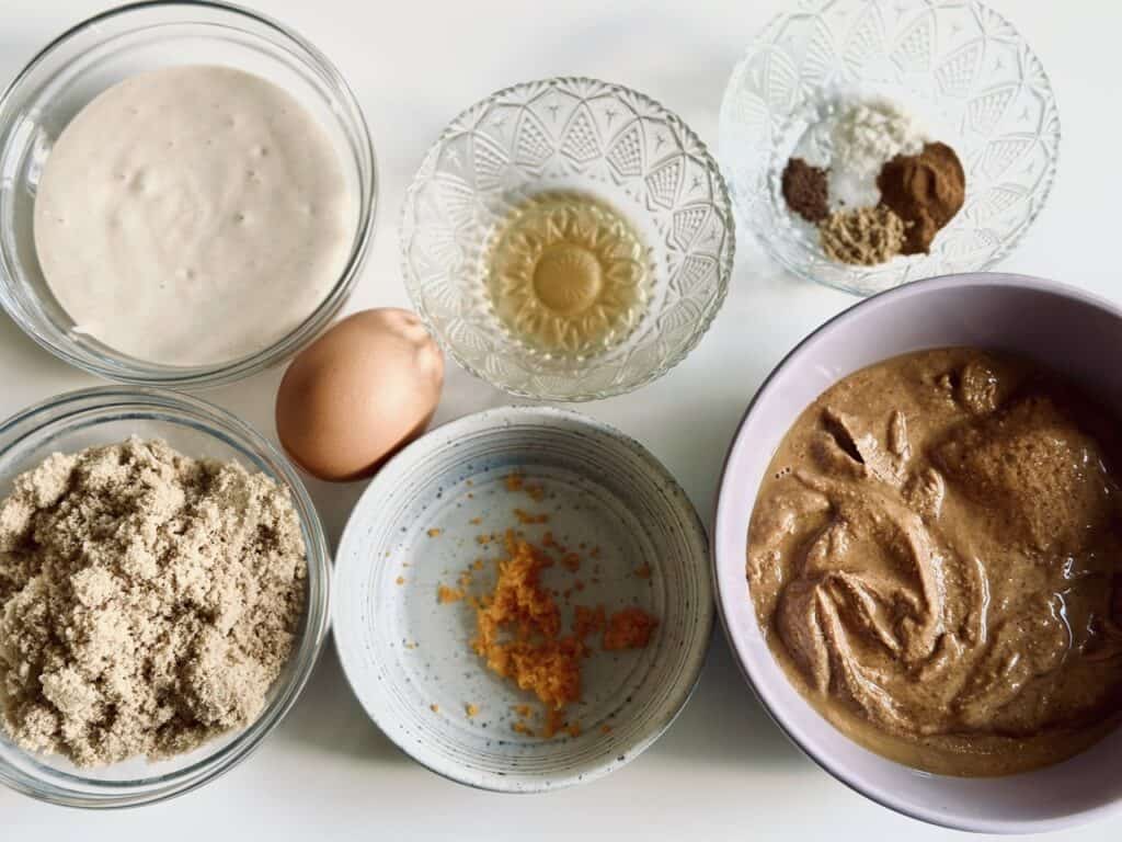 Ingredients needed for sourdough discard spiced peanut butter cookies laid on a table