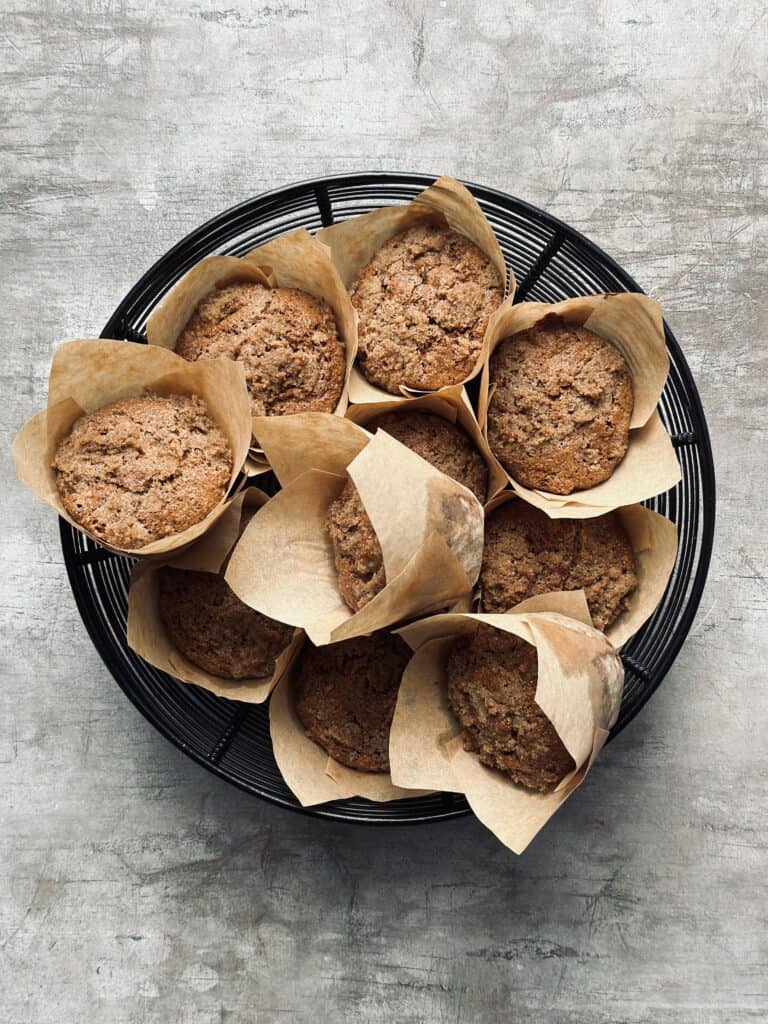 A wire basket with apple rye muffins.