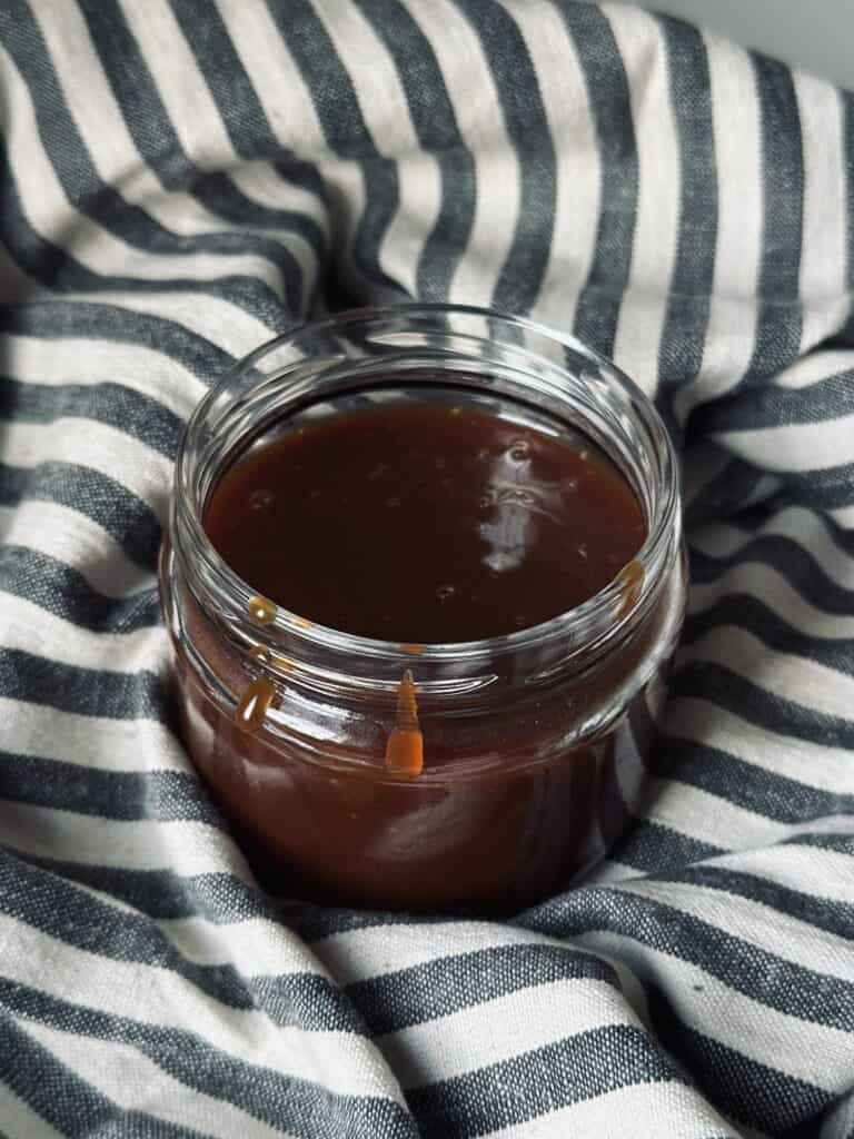 A jar of homemade burnt caramel sauce.