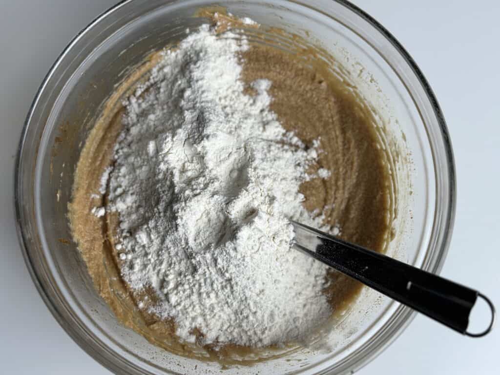 Adding flour to a cookie dough.