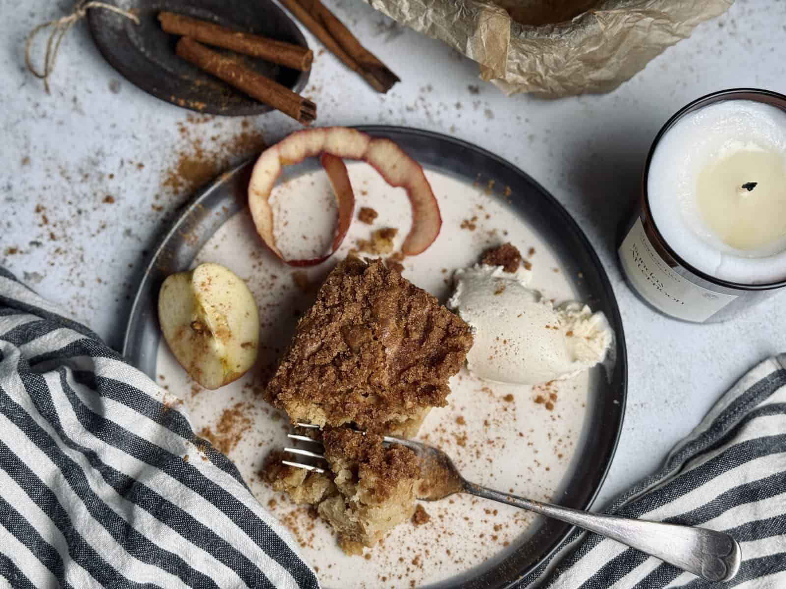 A sourdough apple coffee cake bar served with ice cream and topped with cinnamon crisp