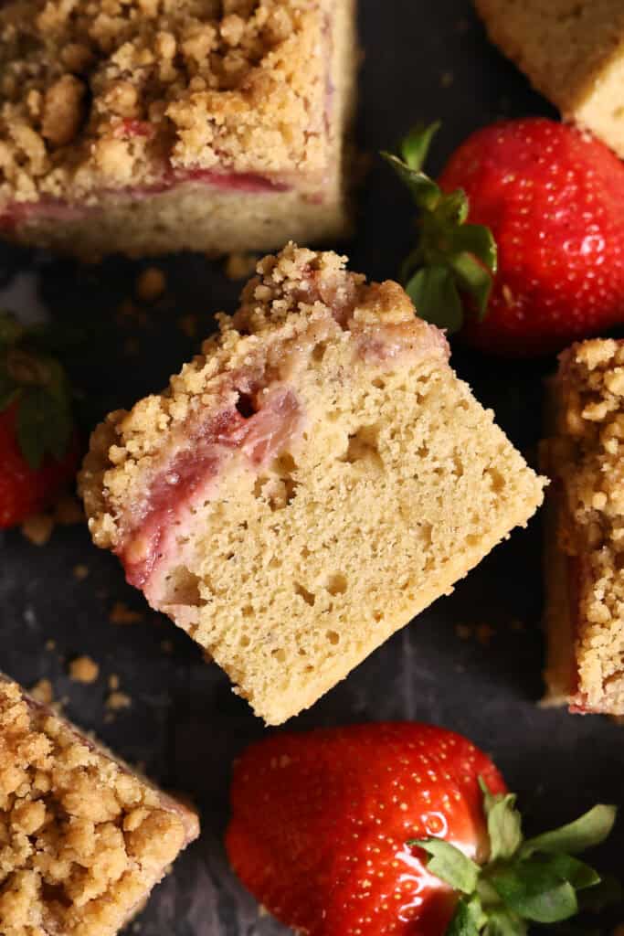 Close-up of a strawberry cake with streusel topping.