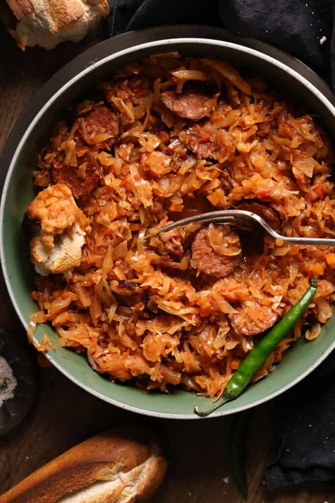 A plate of cabbage and sausage dinner