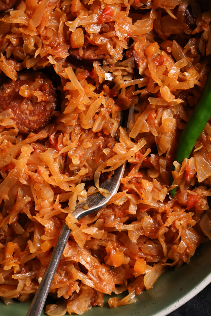 Close-up of a cabbage and sausage dish.